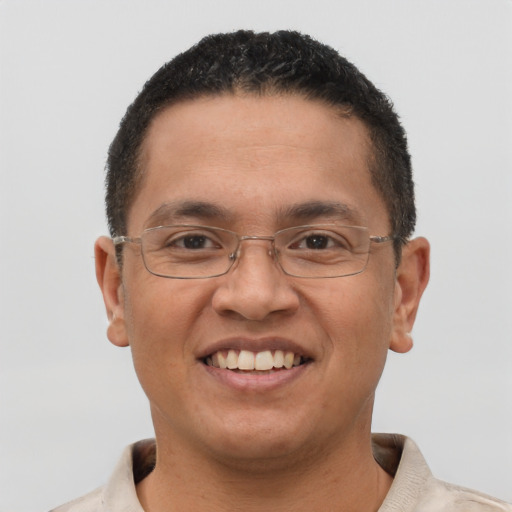 Joyful latino adult male with short  brown hair and brown eyes