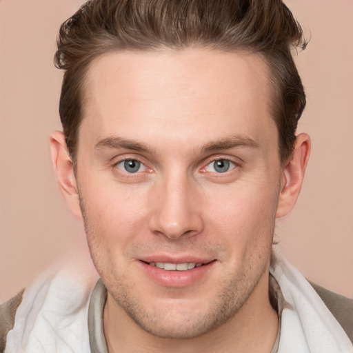 Joyful white young-adult male with short  brown hair and grey eyes