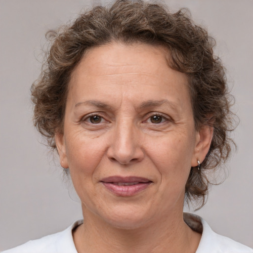 Joyful white middle-aged female with medium  brown hair and brown eyes