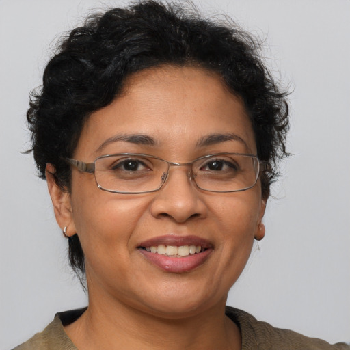 Joyful latino adult female with short  brown hair and brown eyes