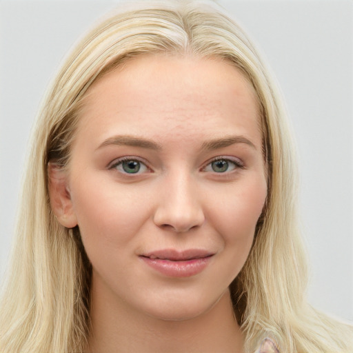 Joyful white young-adult female with long  brown hair and blue eyes