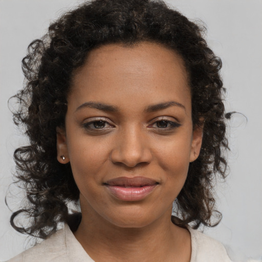 Joyful black young-adult female with medium  brown hair and brown eyes