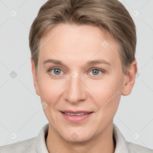 Joyful white adult female with short  brown hair and grey eyes