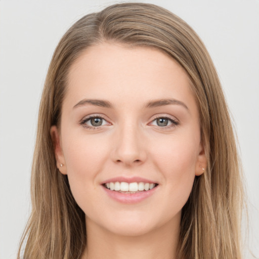 Joyful white young-adult female with long  brown hair and grey eyes