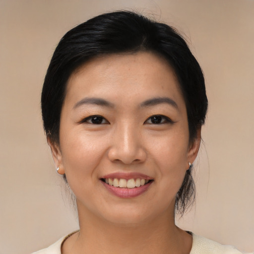 Joyful asian young-adult female with medium  black hair and brown eyes