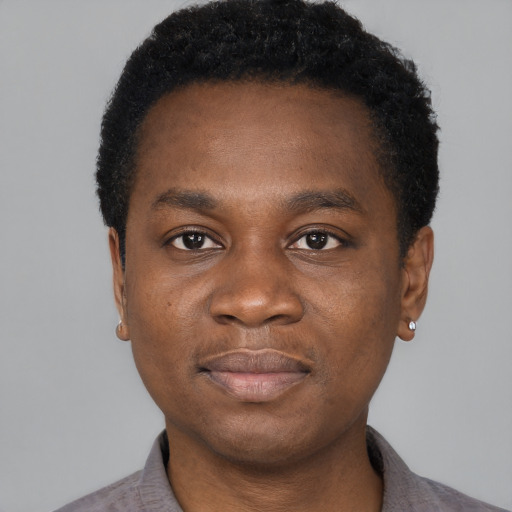 Joyful black young-adult male with short  black hair and brown eyes