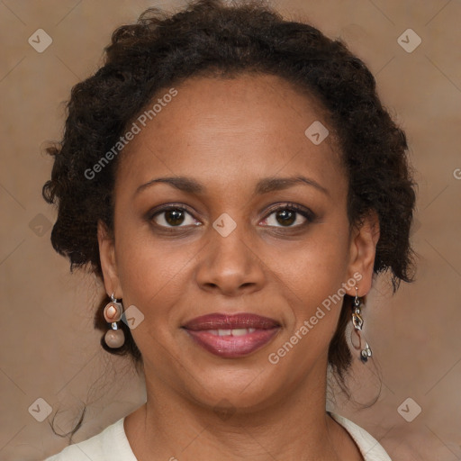 Joyful black adult female with medium  brown hair and brown eyes