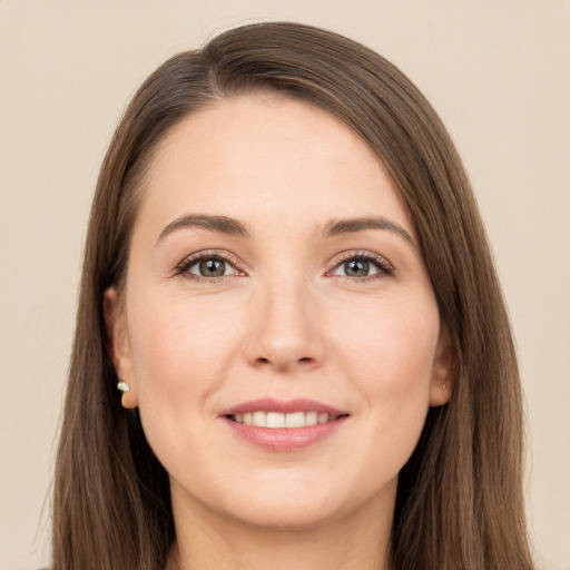 Joyful white young-adult female with long  brown hair and brown eyes