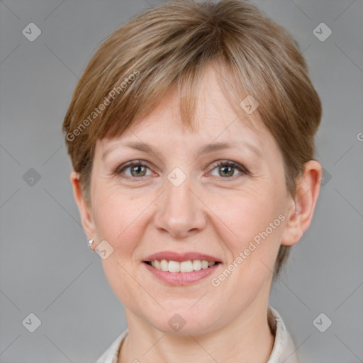 Joyful white adult female with short  brown hair and grey eyes