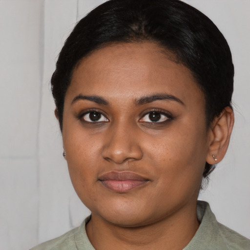 Joyful latino young-adult female with short  black hair and brown eyes