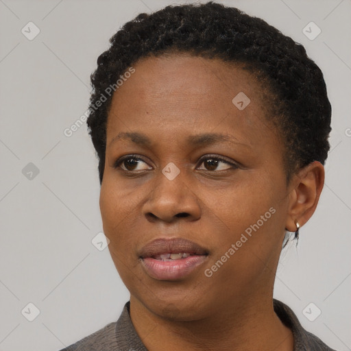 Joyful black young-adult female with short  black hair and brown eyes