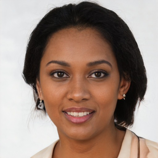 Joyful black young-adult female with medium  brown hair and brown eyes
