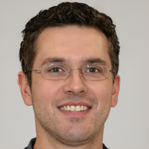 Joyful white adult male with short  brown hair and brown eyes