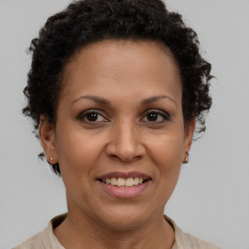 Joyful latino adult female with short  brown hair and brown eyes