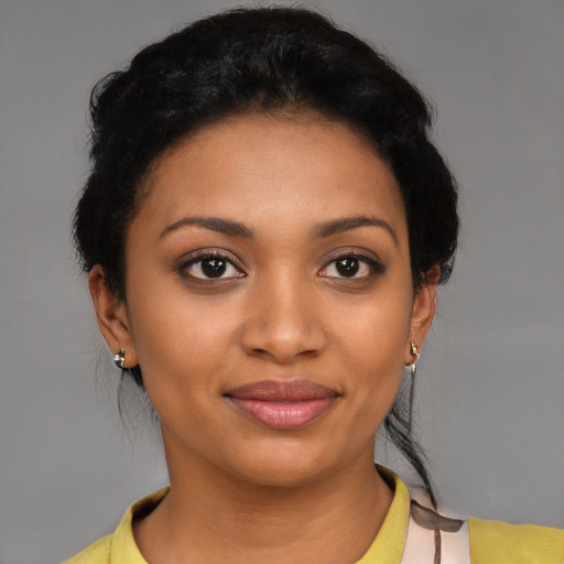 Joyful black young-adult female with short  black hair and brown eyes