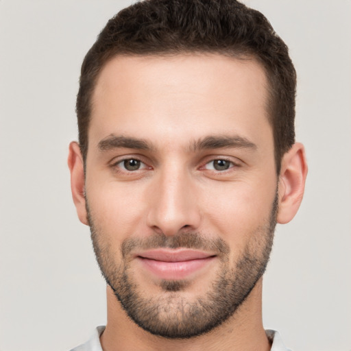 Joyful white young-adult male with short  brown hair and brown eyes