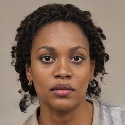 Neutral black young-adult female with medium  brown hair and brown eyes