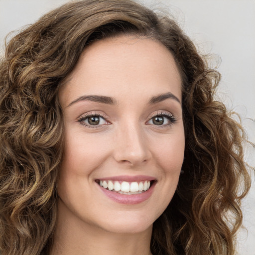 Joyful white young-adult female with long  brown hair and green eyes