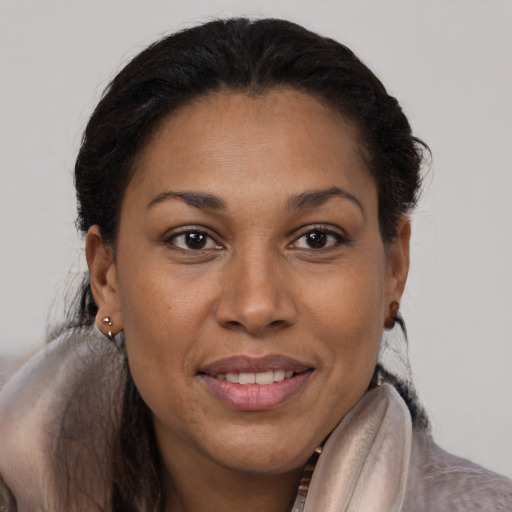 Joyful black young-adult female with medium  brown hair and brown eyes