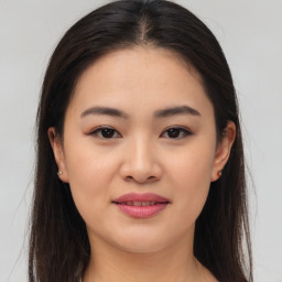 Joyful asian young-adult female with long  brown hair and brown eyes