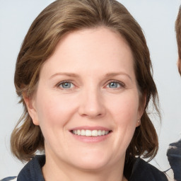 Joyful white young-adult female with medium  brown hair and blue eyes