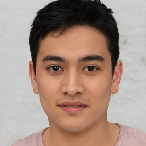 Joyful asian young-adult male with short  black hair and brown eyes