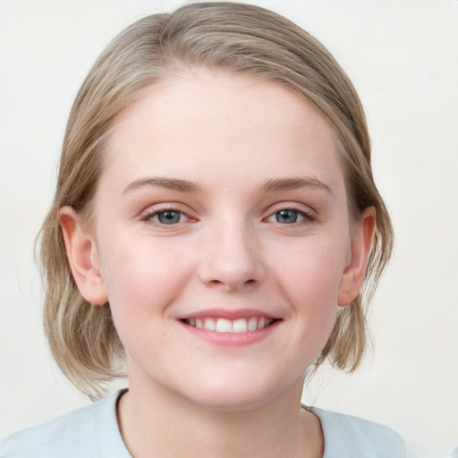 Joyful white child female with medium  brown hair and blue eyes