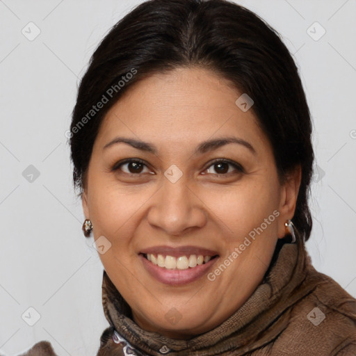 Joyful latino adult female with medium  brown hair and brown eyes