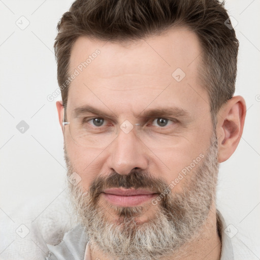 Joyful white adult male with short  brown hair and grey eyes