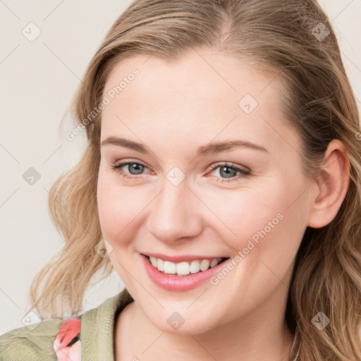 Joyful white young-adult female with long  brown hair and blue eyes