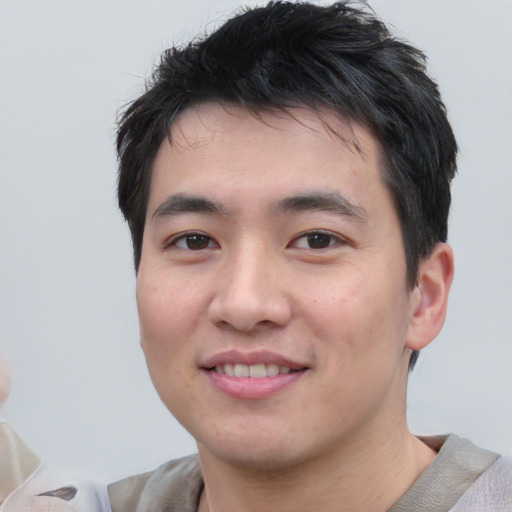 Joyful white young-adult male with short  black hair and brown eyes