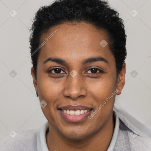 Joyful black young-adult female with short  black hair and brown eyes