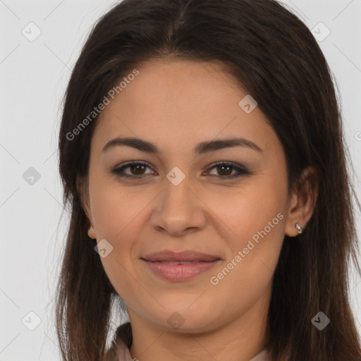 Joyful latino young-adult female with long  brown hair and brown eyes