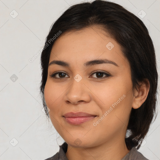 Joyful latino young-adult female with medium  brown hair and brown eyes