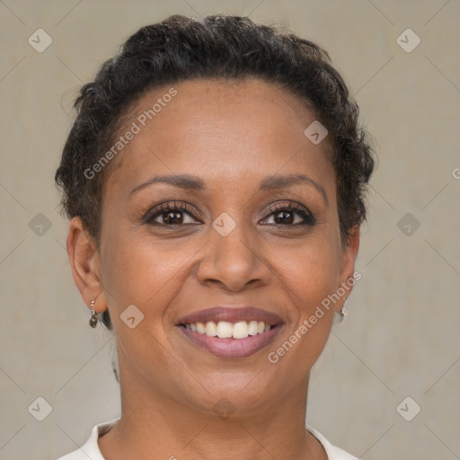 Joyful black adult female with short  brown hair and brown eyes