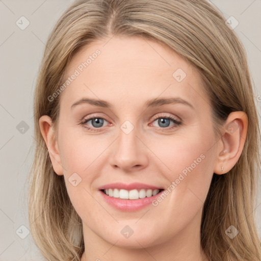 Joyful white young-adult female with long  brown hair and blue eyes