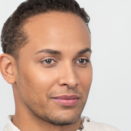 Joyful latino young-adult male with short  brown hair and brown eyes