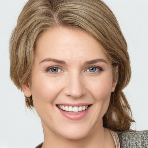 Joyful white young-adult female with medium  brown hair and blue eyes