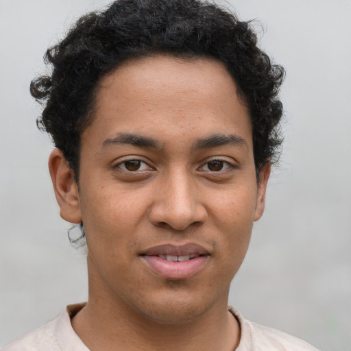 Joyful latino young-adult male with short  brown hair and brown eyes