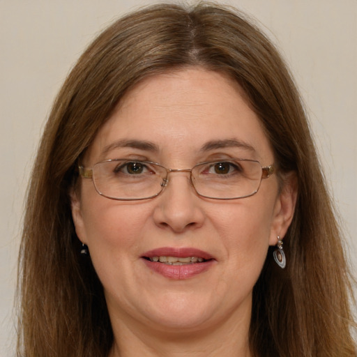 Joyful white adult female with long  brown hair and green eyes