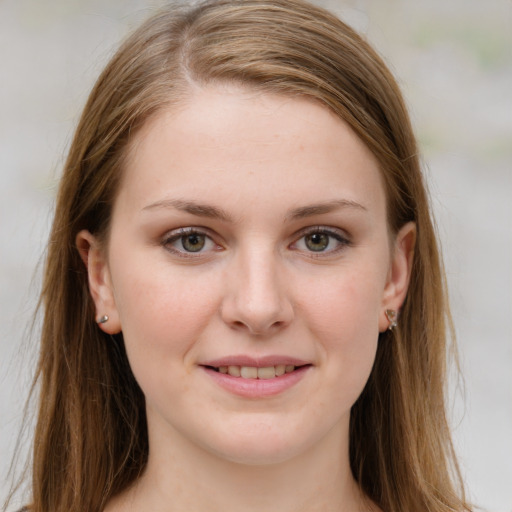 Joyful white young-adult female with long  brown hair and green eyes