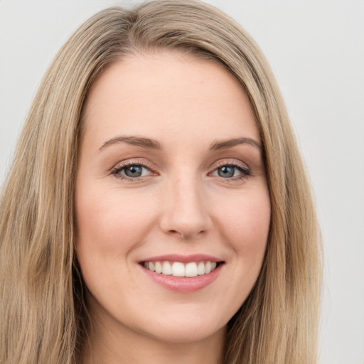 Joyful white young-adult female with long  brown hair and green eyes