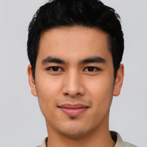 Joyful asian young-adult male with short  black hair and brown eyes