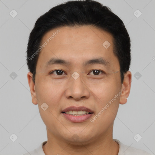 Joyful asian young-adult male with short  black hair and brown eyes