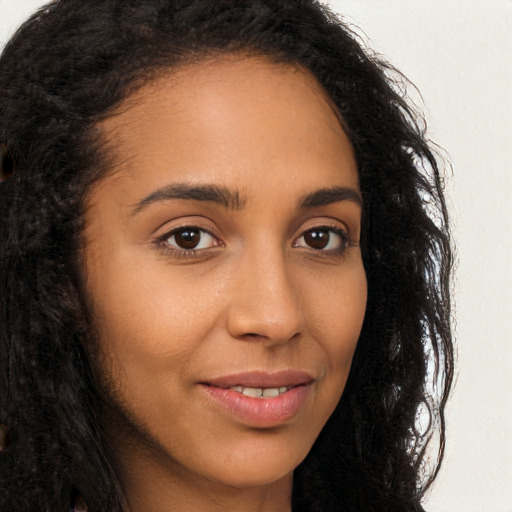 Joyful latino young-adult female with long  brown hair and brown eyes