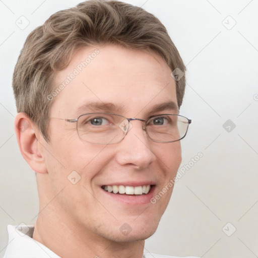 Joyful white adult male with short  brown hair and grey eyes