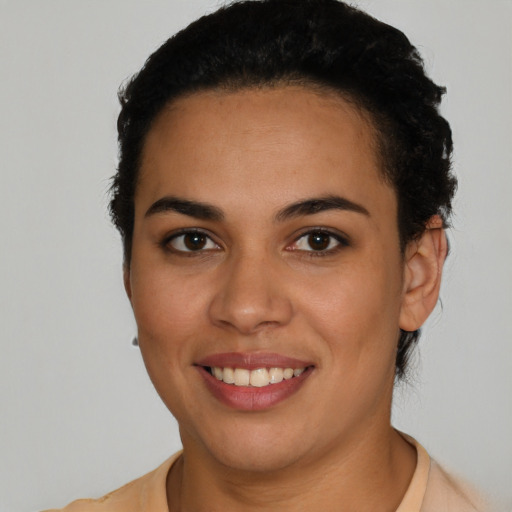 Joyful latino young-adult female with short  brown hair and brown eyes