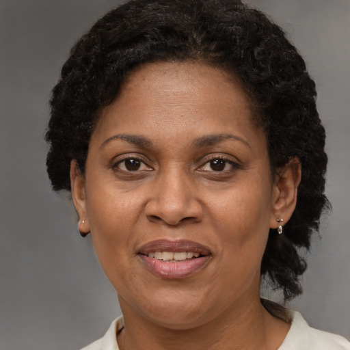 Joyful latino adult female with short  brown hair and brown eyes