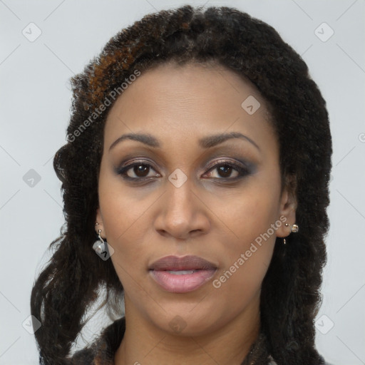 Joyful black young-adult female with long  brown hair and brown eyes