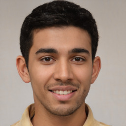 Joyful latino young-adult male with short  brown hair and brown eyes